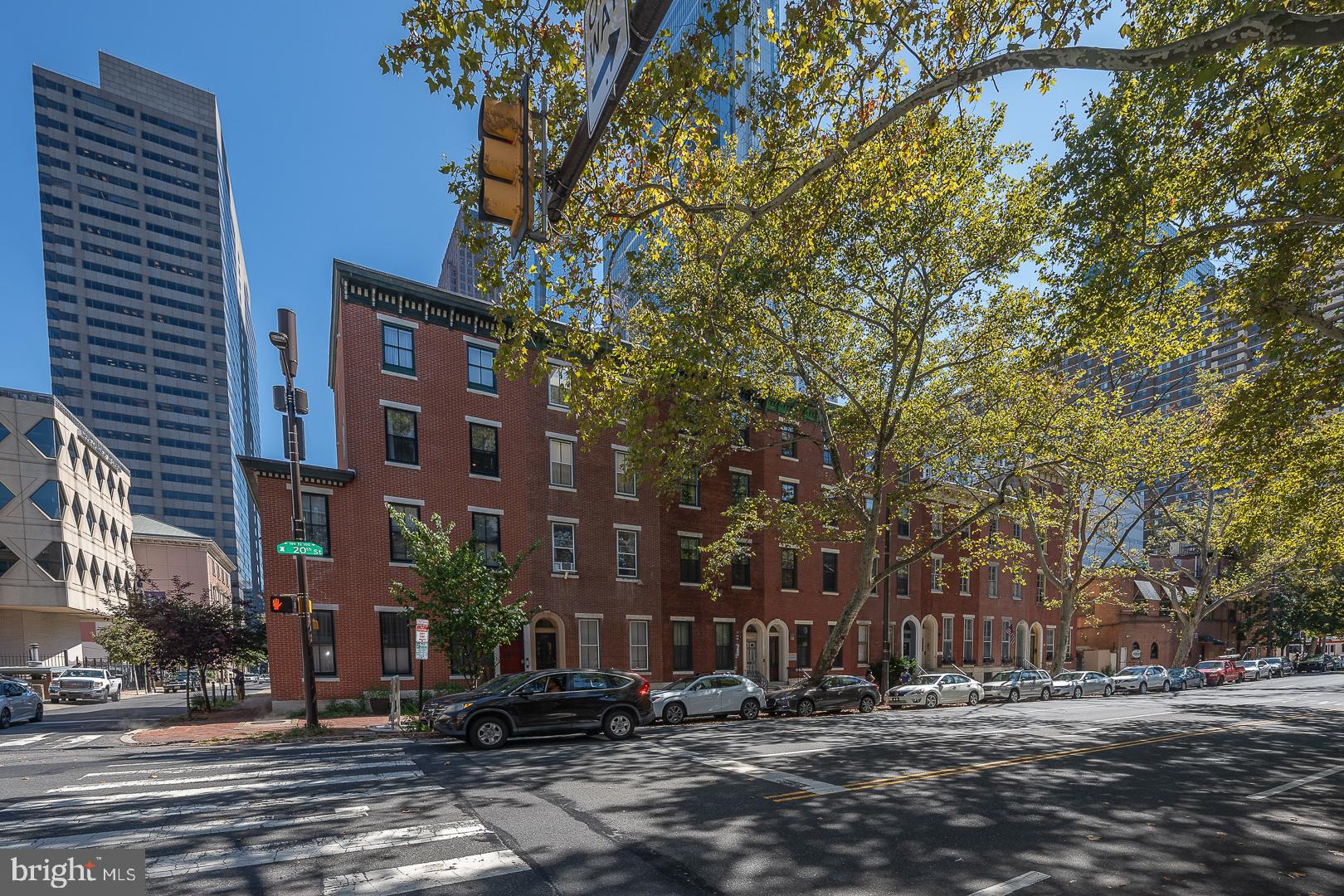 a front view of a building with trees