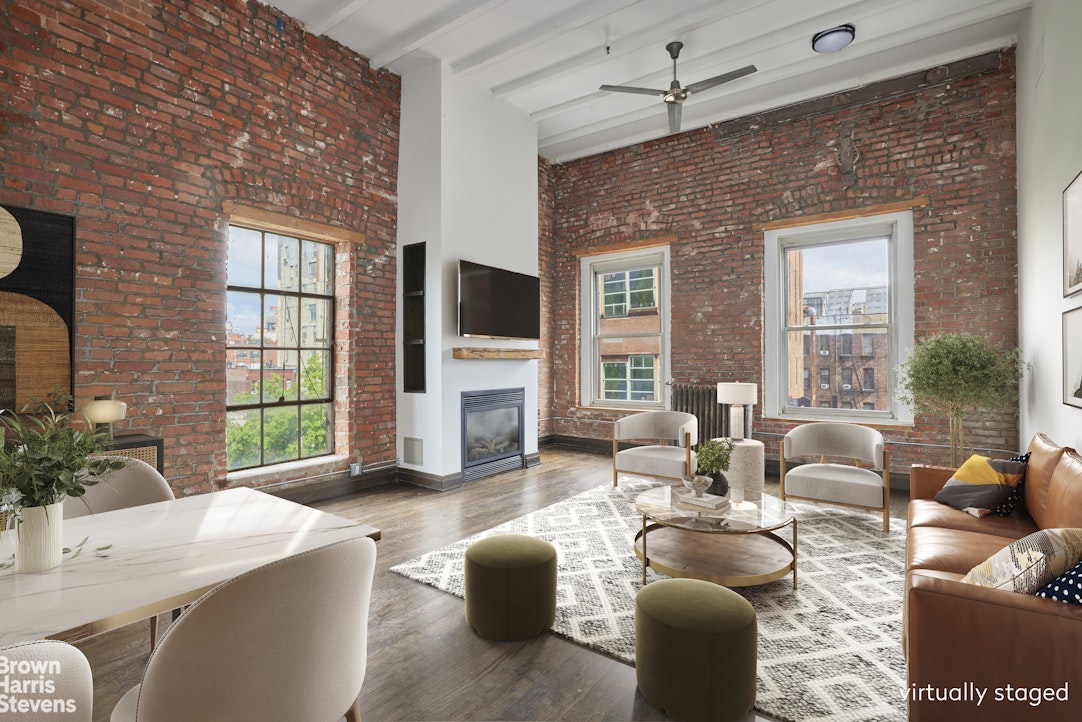 a living room with furniture a fireplace and a flat screen tv