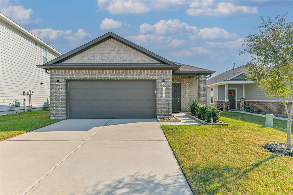 a front view of a house with a yard and garage