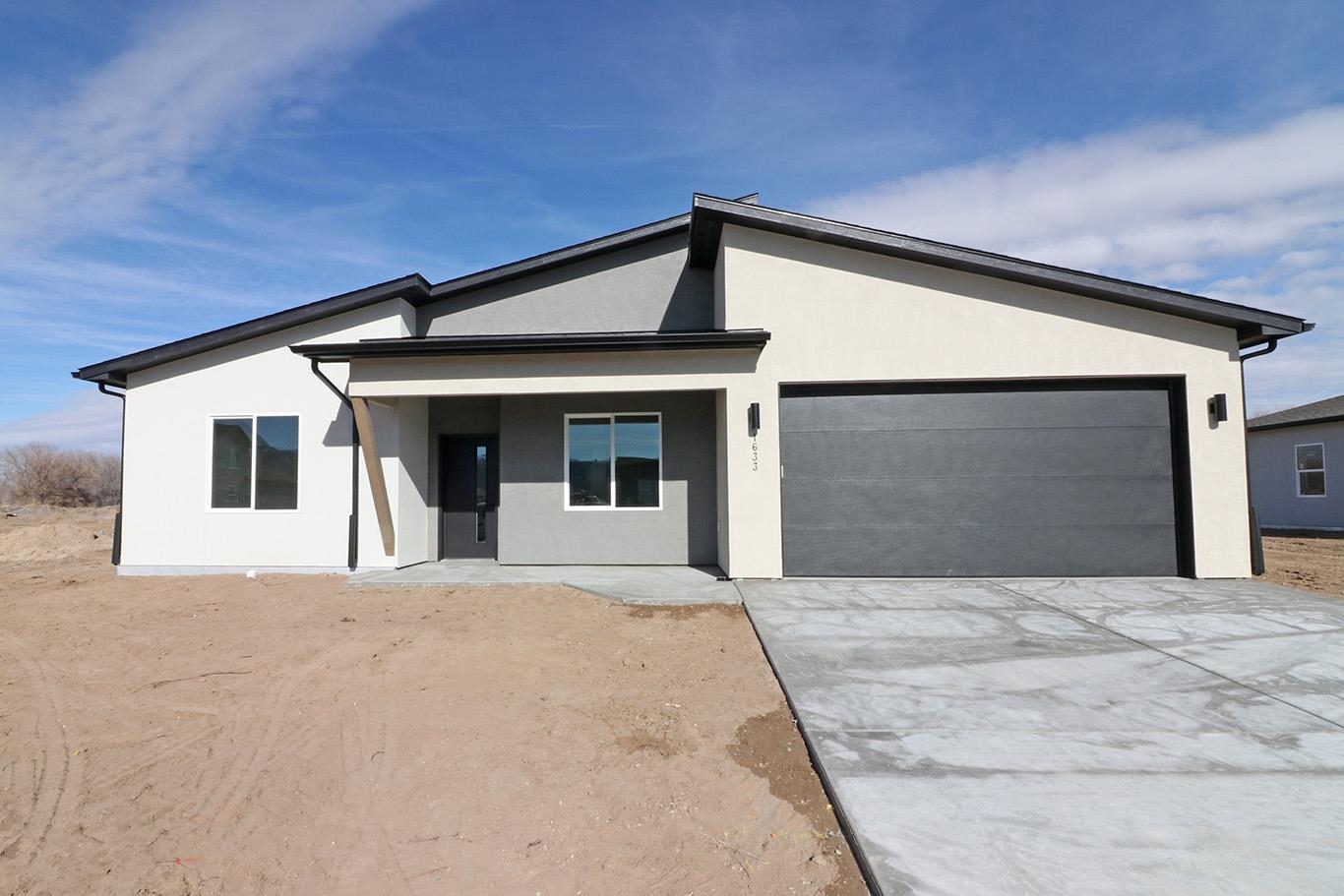 a front view of a house with yard and garage