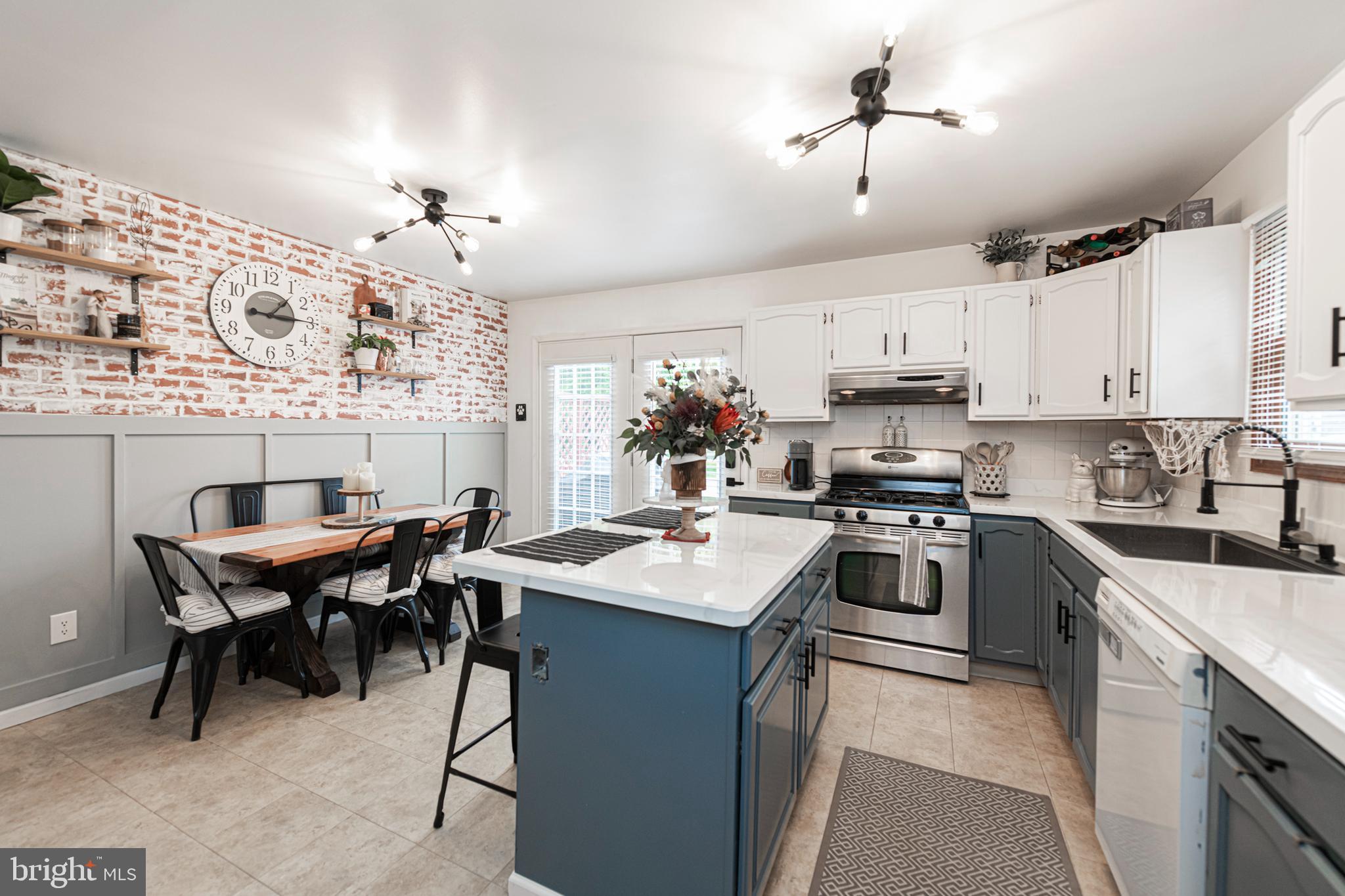 a kitchen with cabinets appliances and a dining table