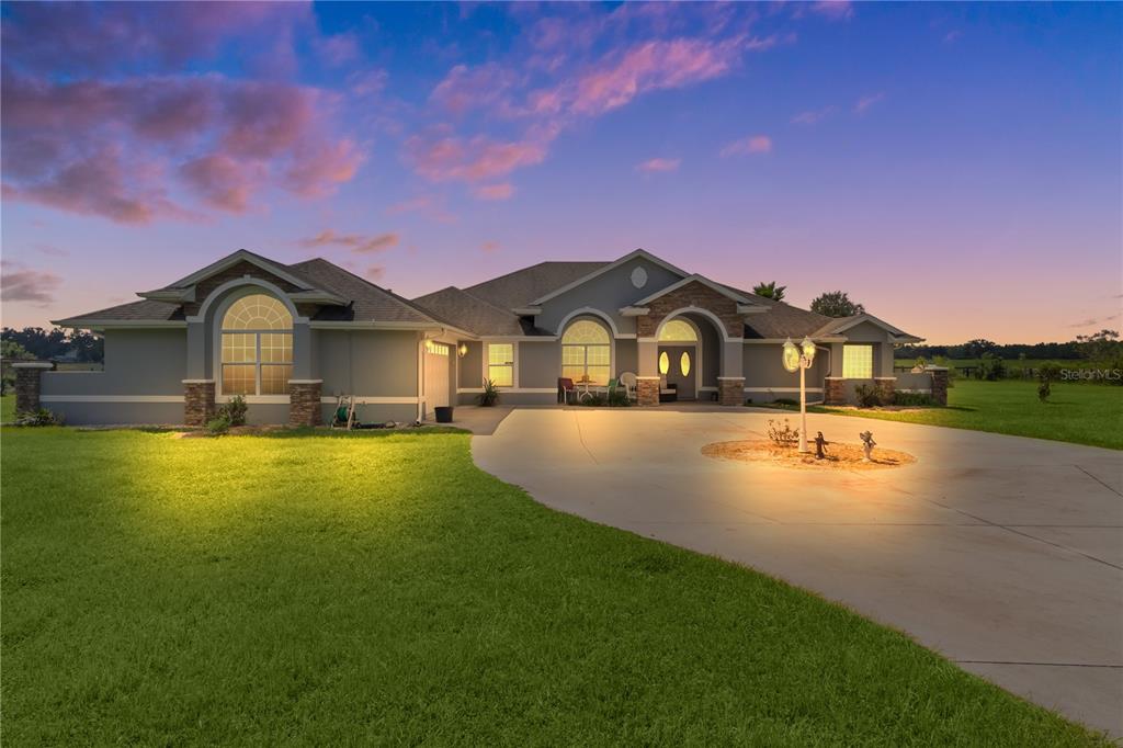 a view of a house with a big yard next to a house