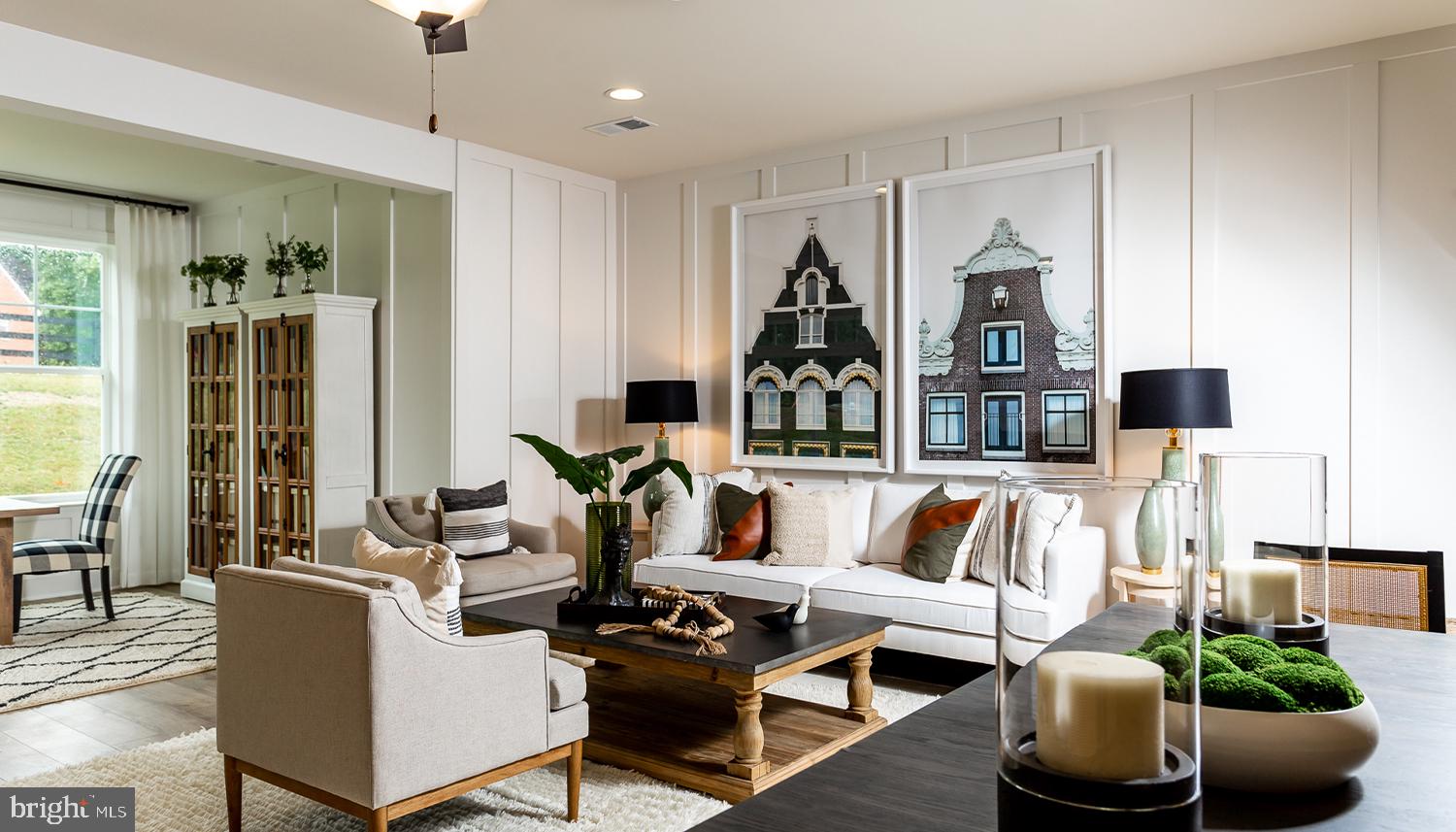 a living room with furniture a rug and white walls