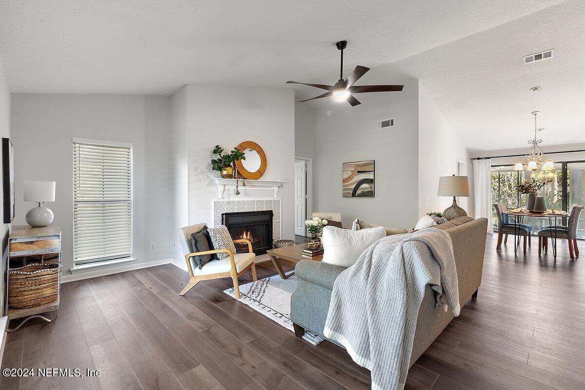 a living room with furniture a fireplace and a table