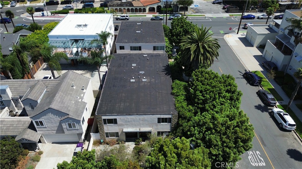 an aerial view of multiple houses with a yard