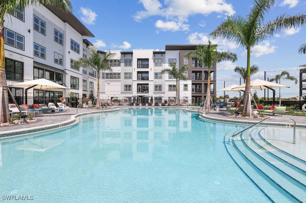 a swimming pool view with a outdoor seating