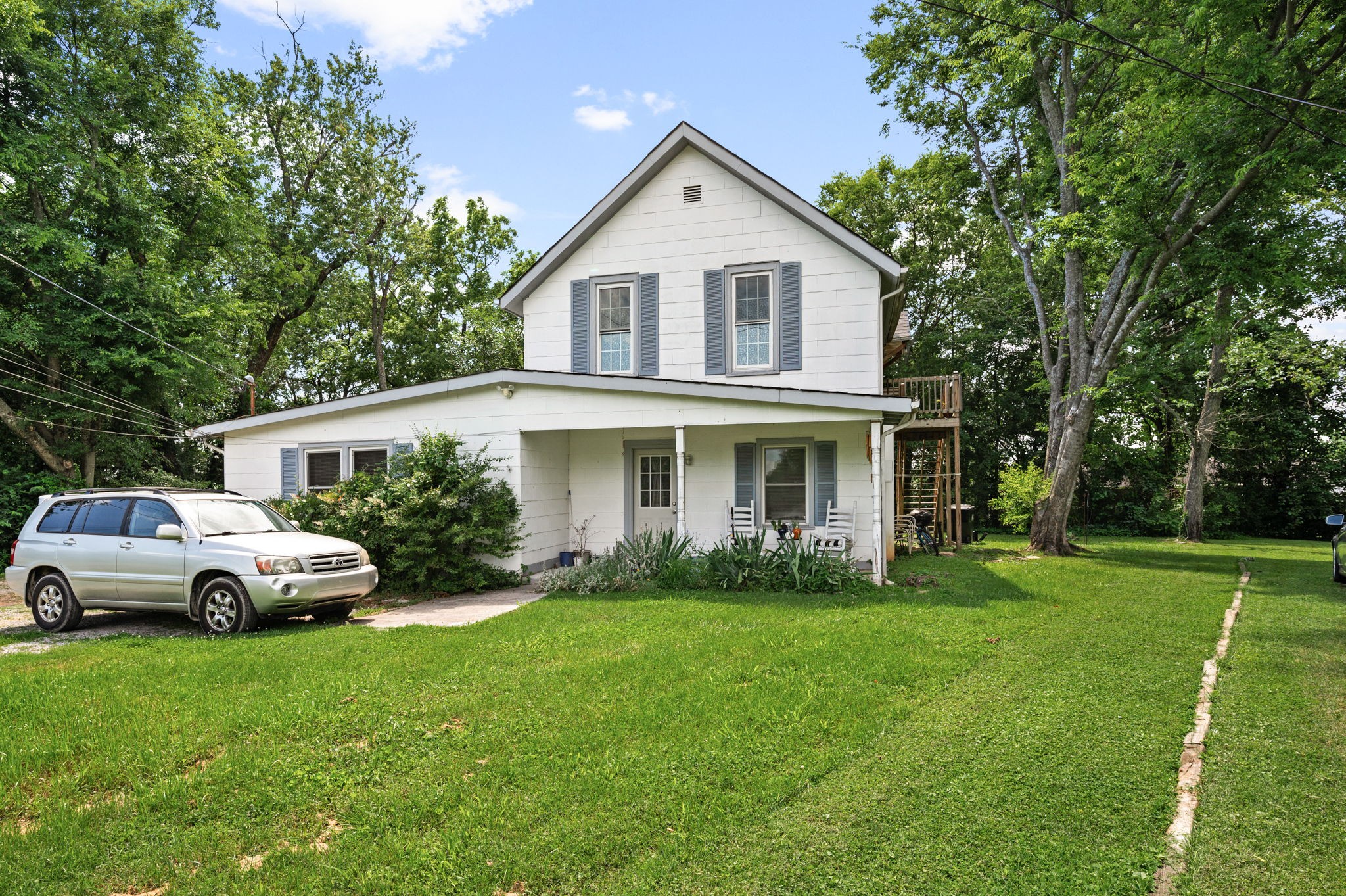 a front view of house with yard and green space