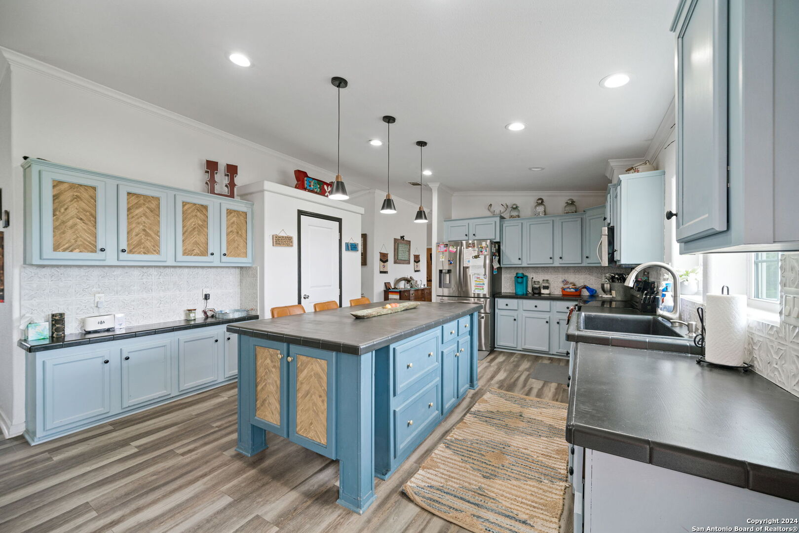 a kitchen with stainless steel appliances granite countertop a sink stove and cabinets