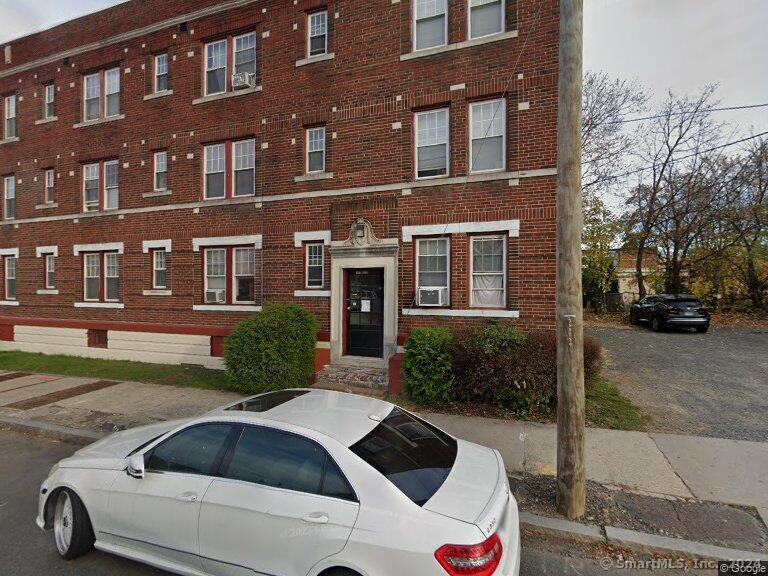 a view of a brick house with a yard