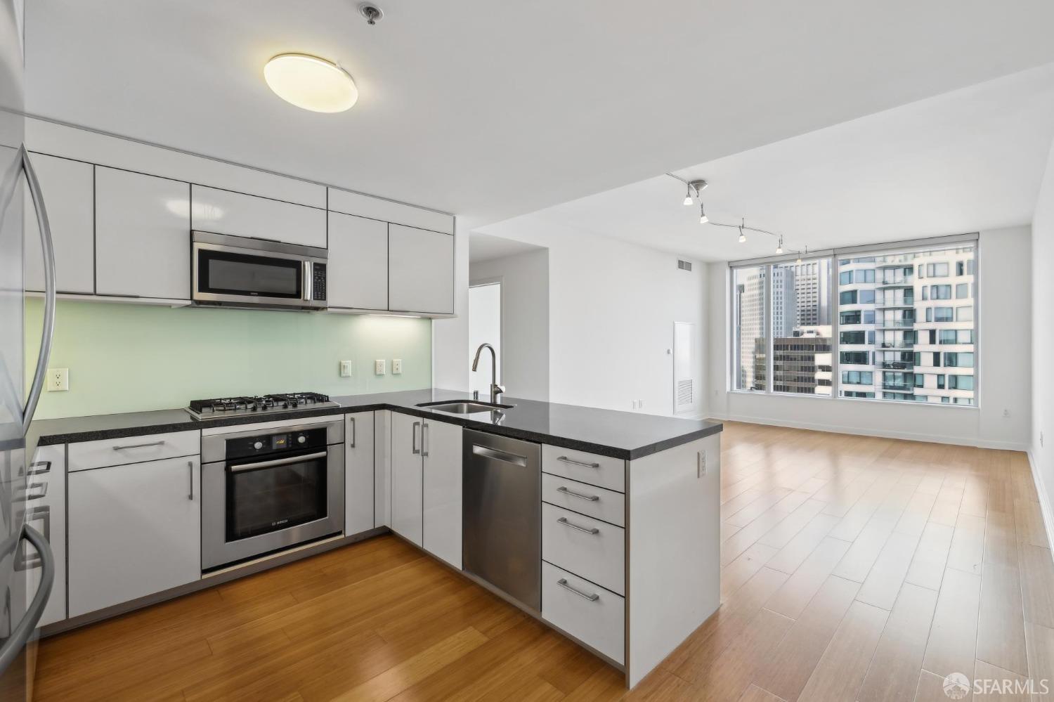 a kitchen with granite countertop a stove and a sink