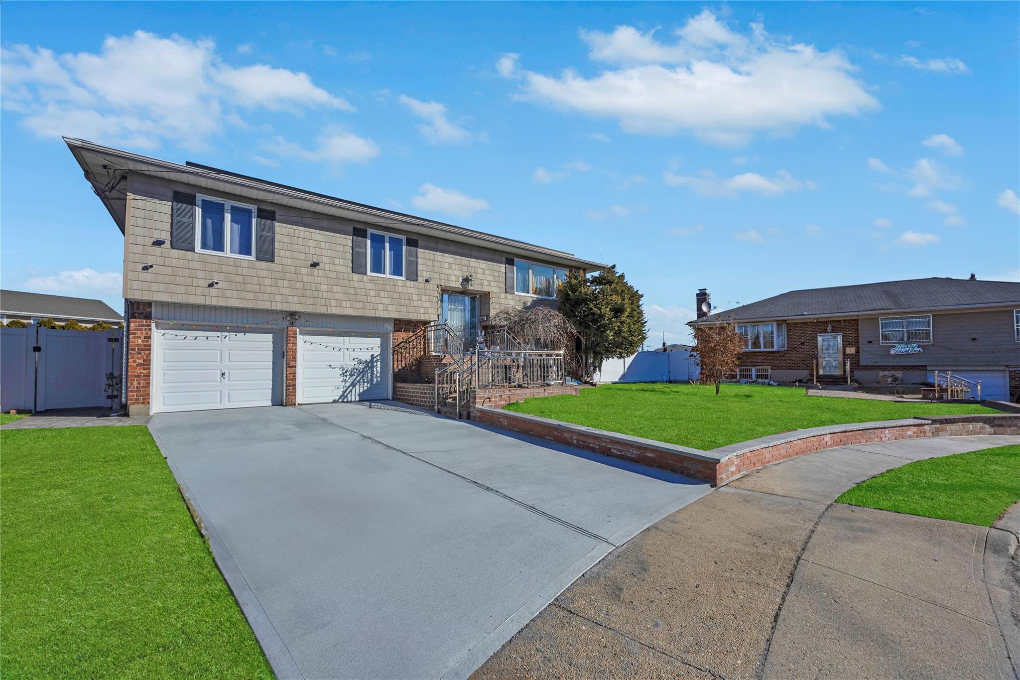 View of front of home with a garage and a front yard