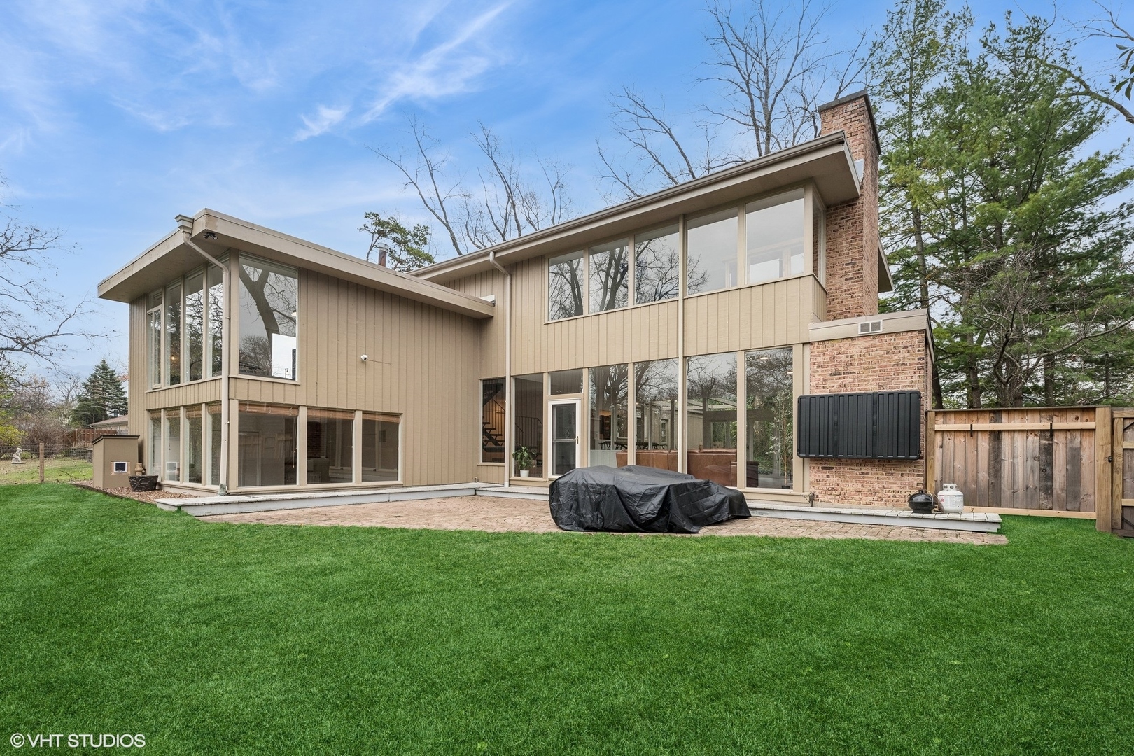 a front view of house with yard and green space