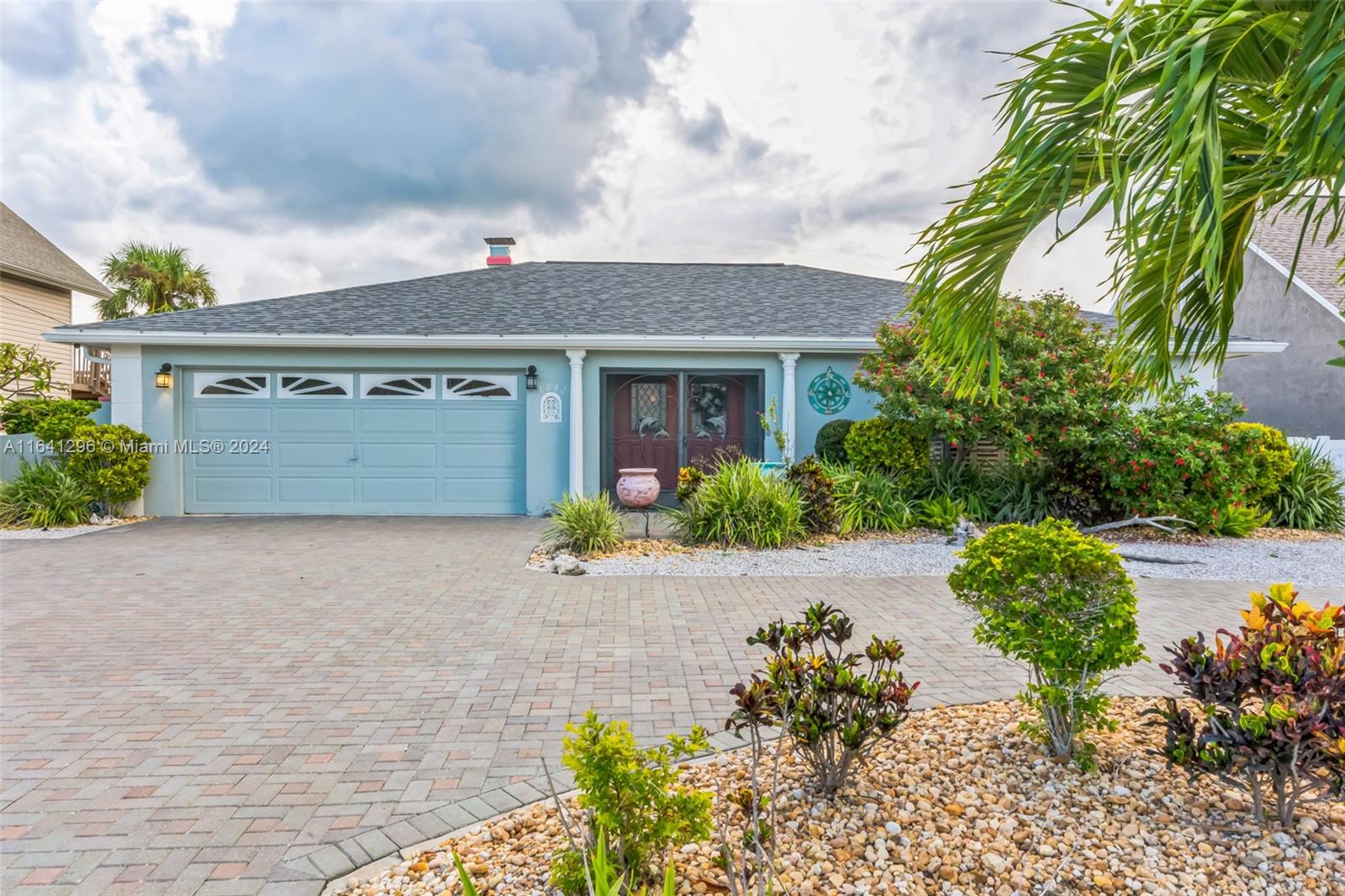 a front view of a house with a yard and a garage