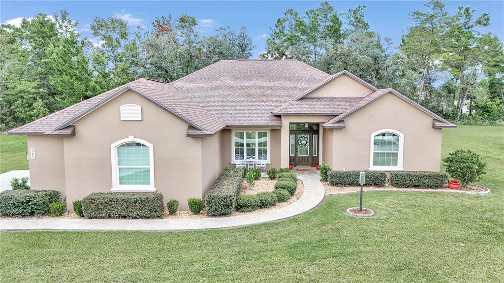 a front view of a house with a yard and garage