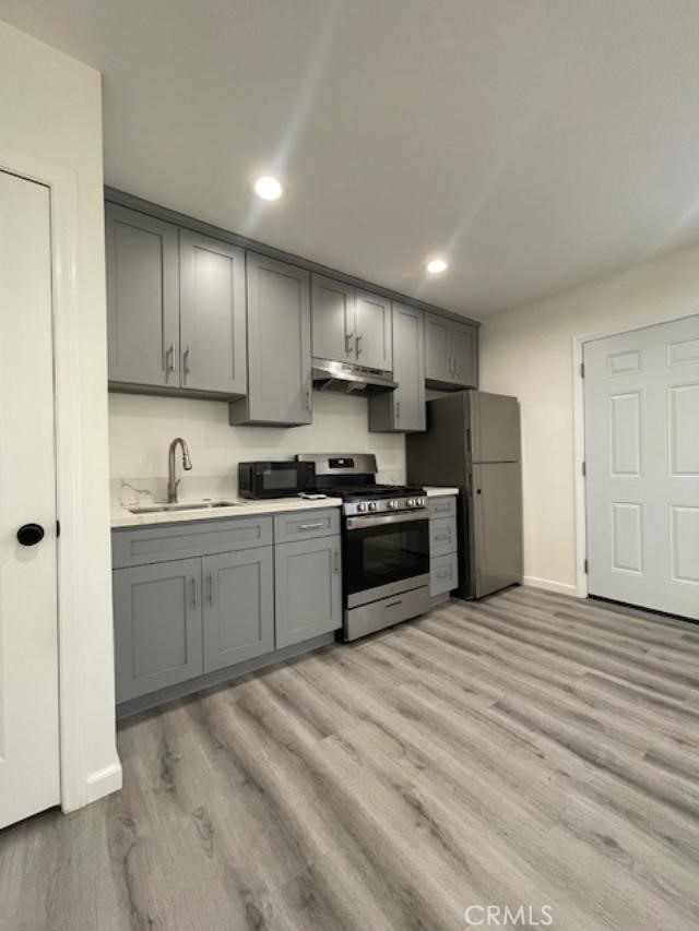 a kitchen with stainless steel appliances granite countertop a refrigerator sink and cabinets