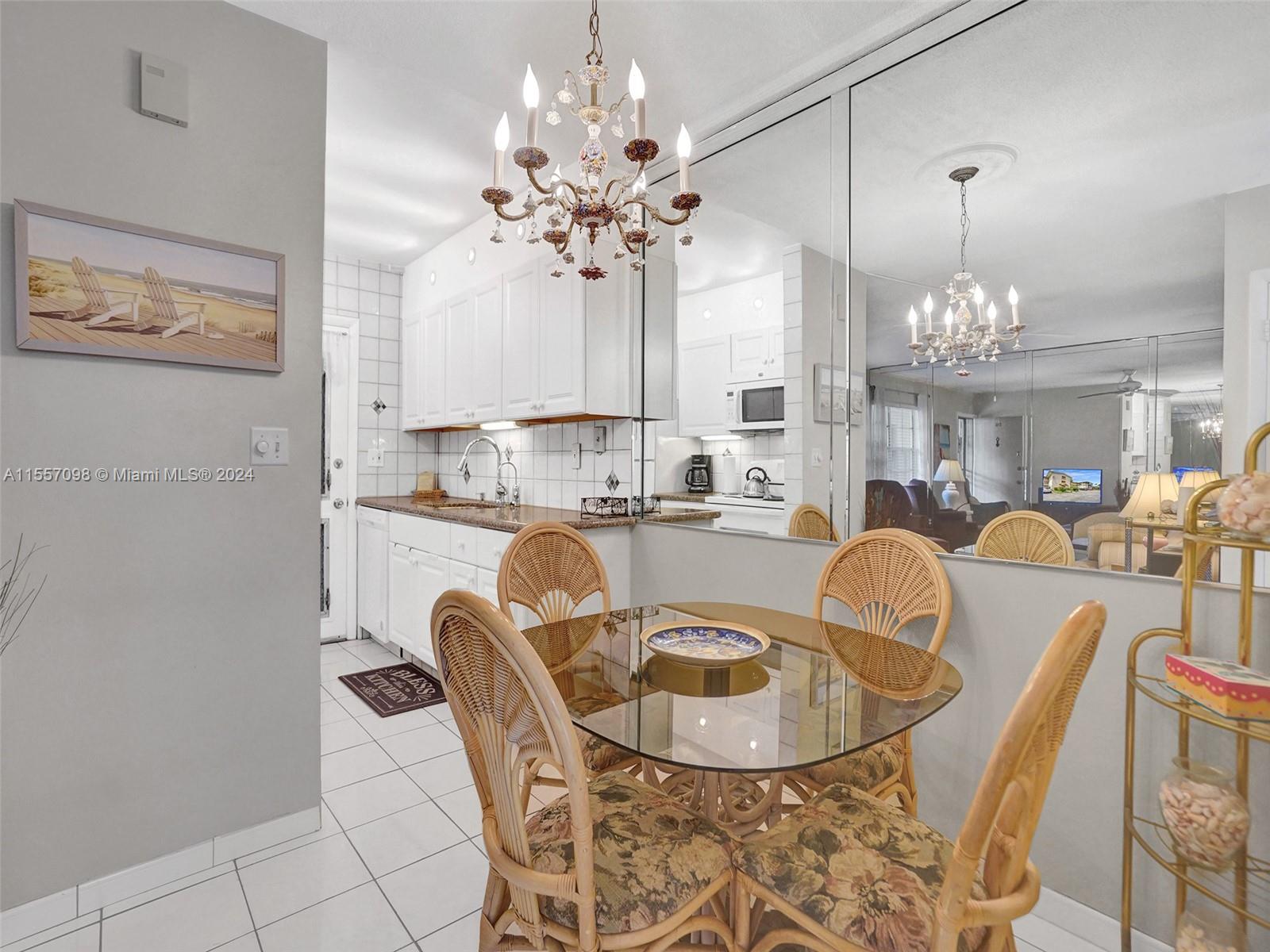 a dining room with furniture a chandelier and window