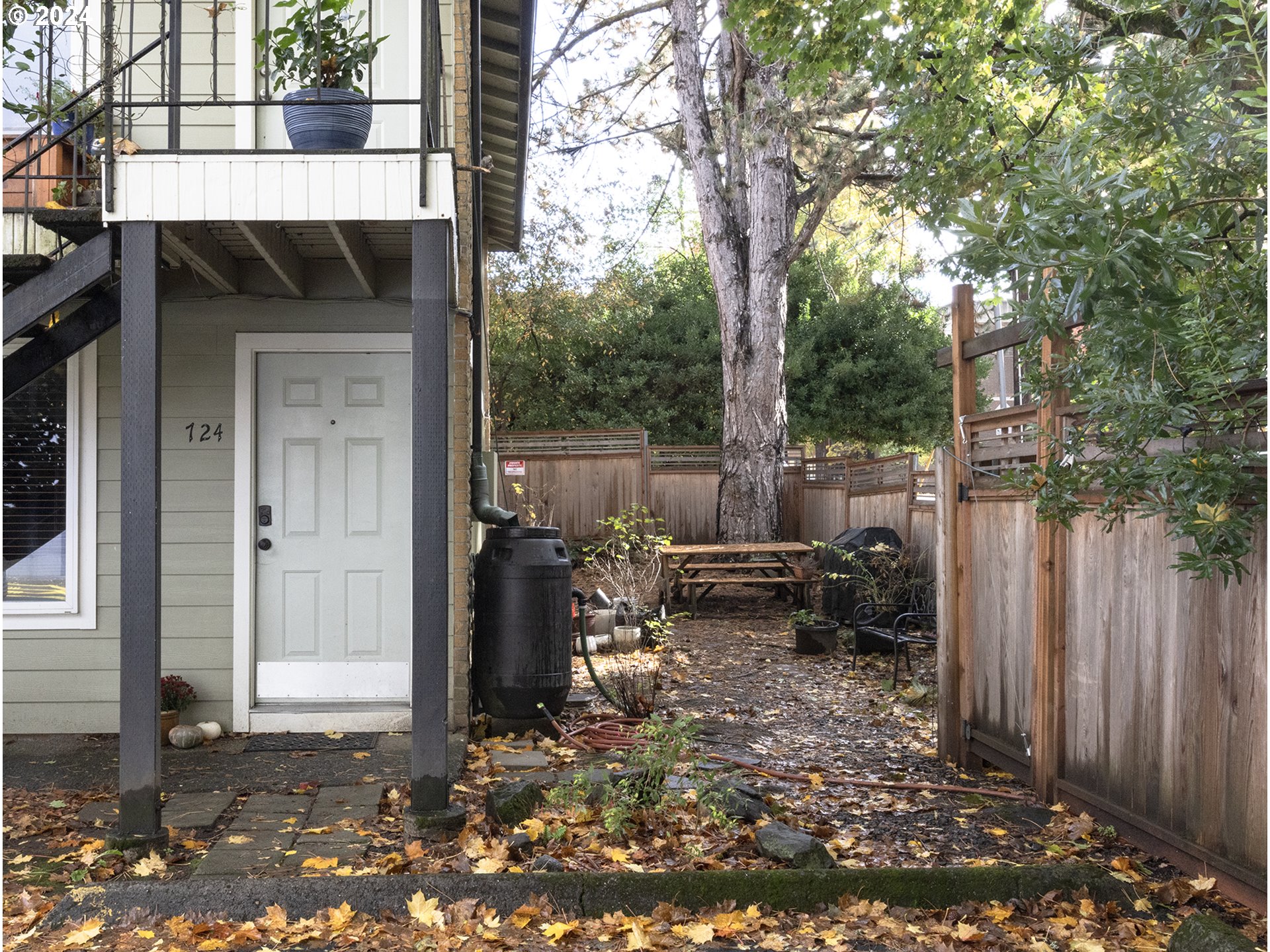 a backyard of a house with barbeque oven and outdoor seating