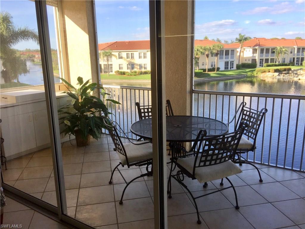 a view of a balcony with table and chairs