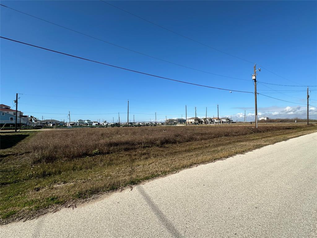 a view of a road with a field