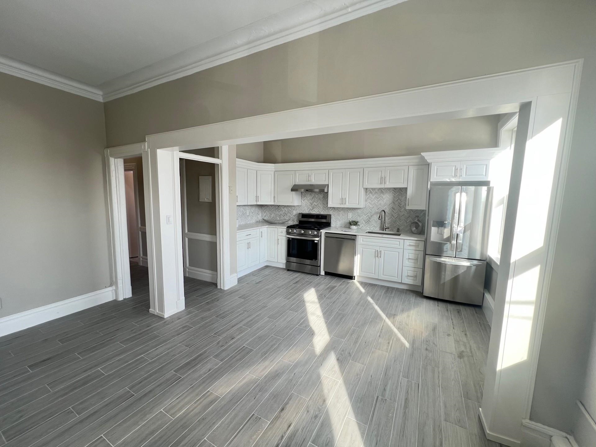 a kitchen with stainless steel appliances a refrigerator and a stove top oven