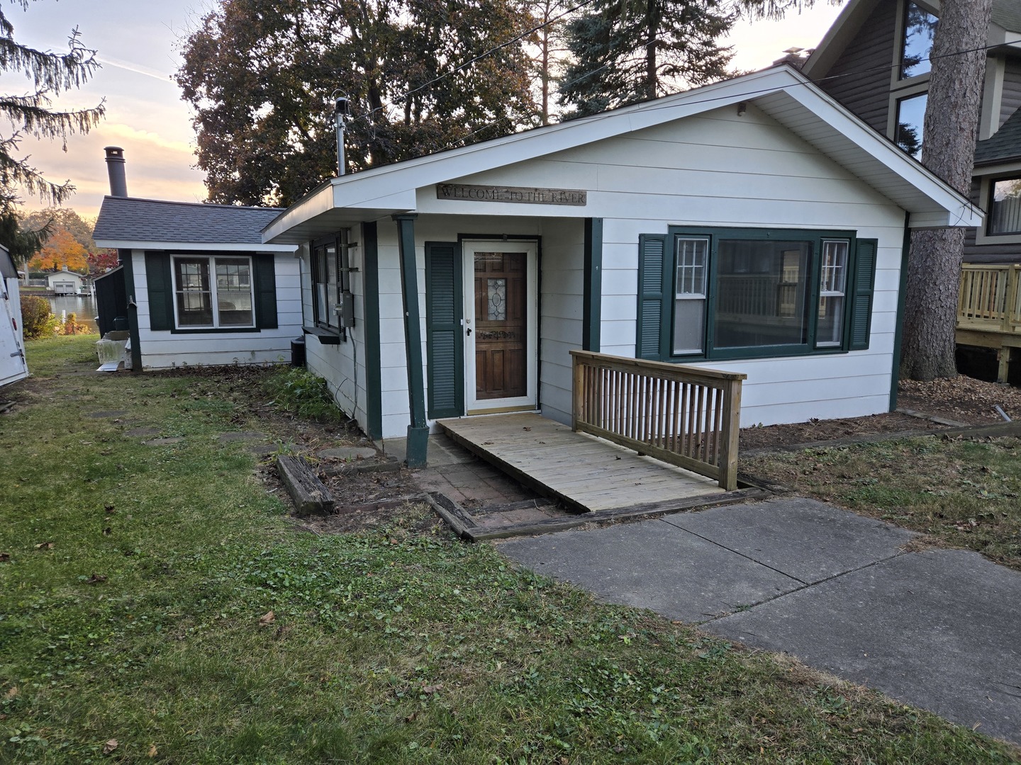 a view of a house with a yard and porch