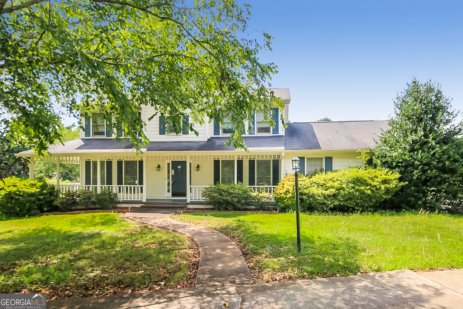 a front view of a house with a garden