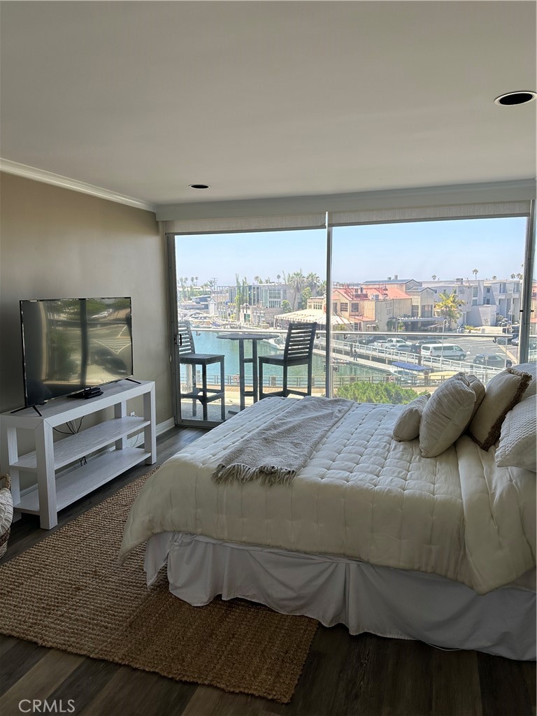 a bedroom with a bed and large window