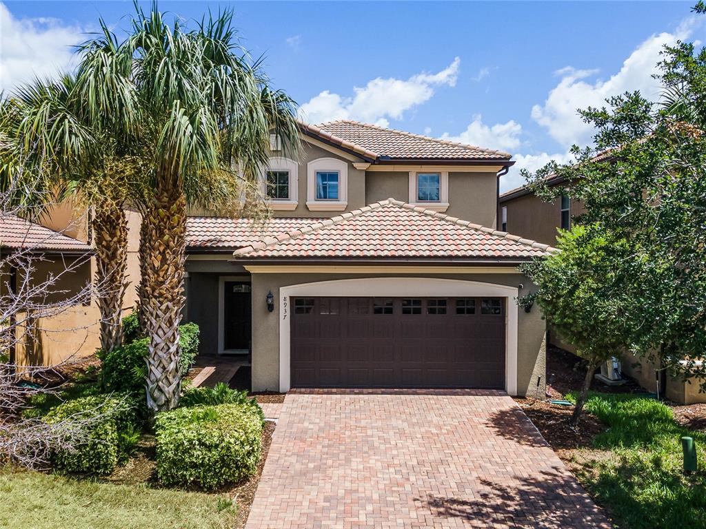 a front view of a house with a yard and garage