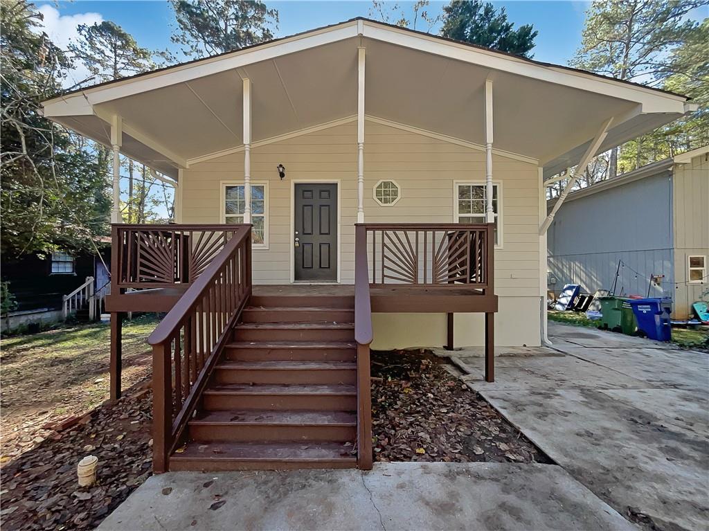 a view of a porch with wooden floor and stairs