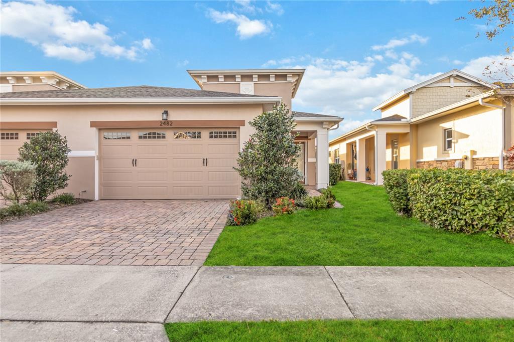 a front view of a house with a yard and garage