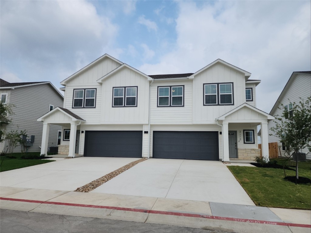 a front view of a house with yard and garage