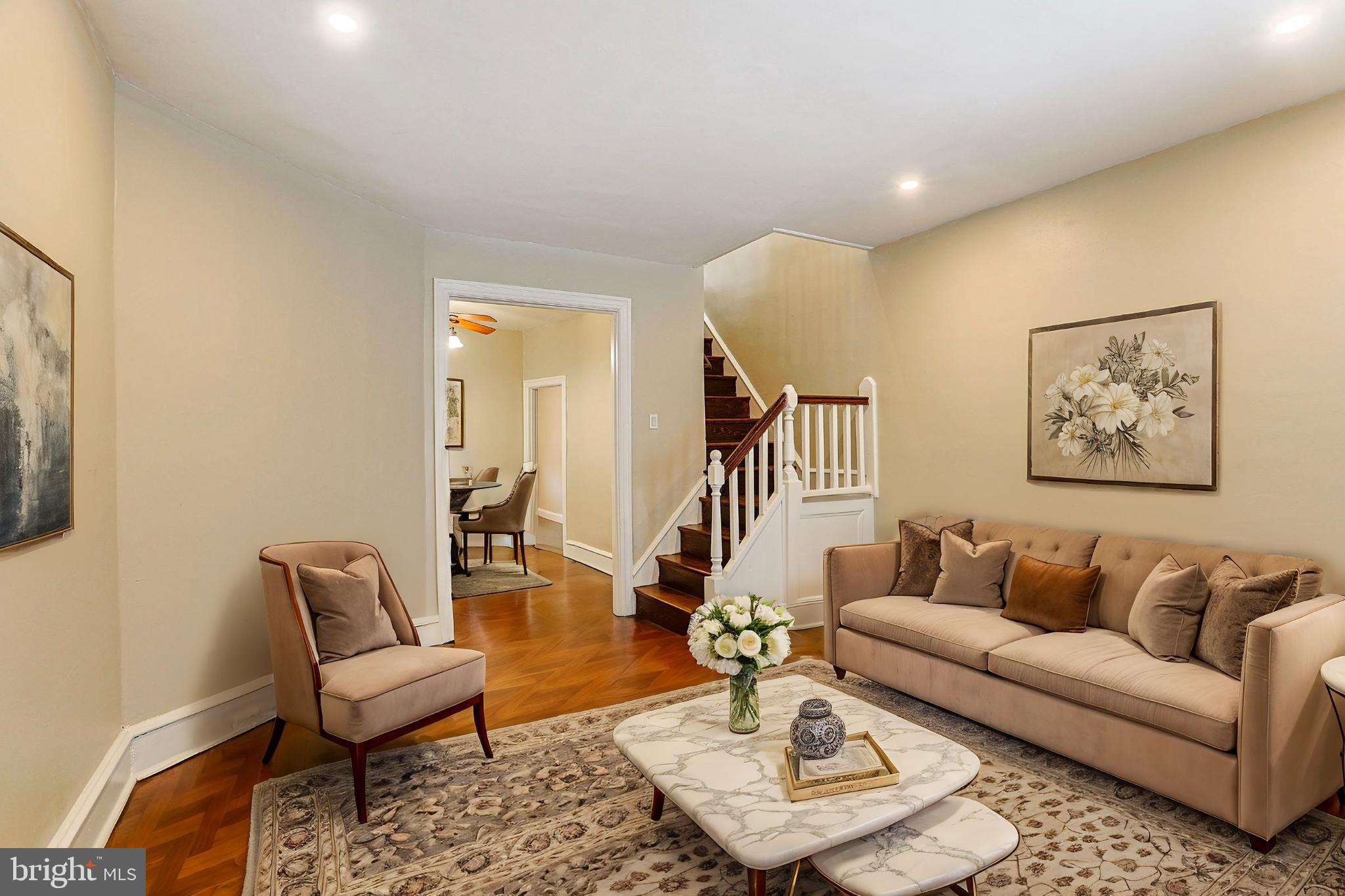 a living room with furniture and a wooden floor