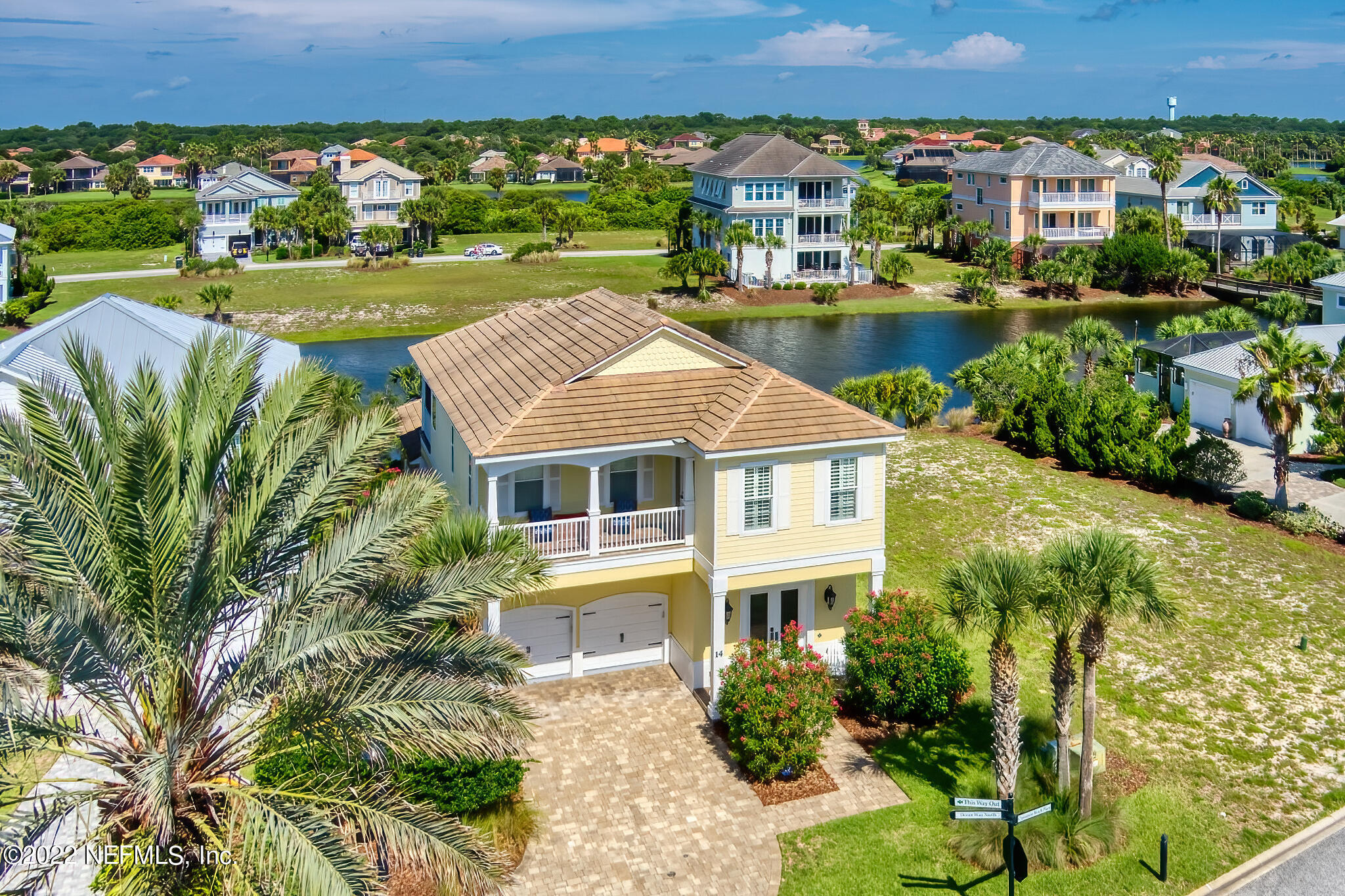 an aerial view of a house with a garden and lake view