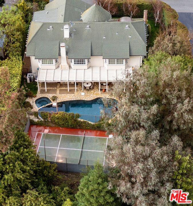 an aerial view of a house with a yard and lake view