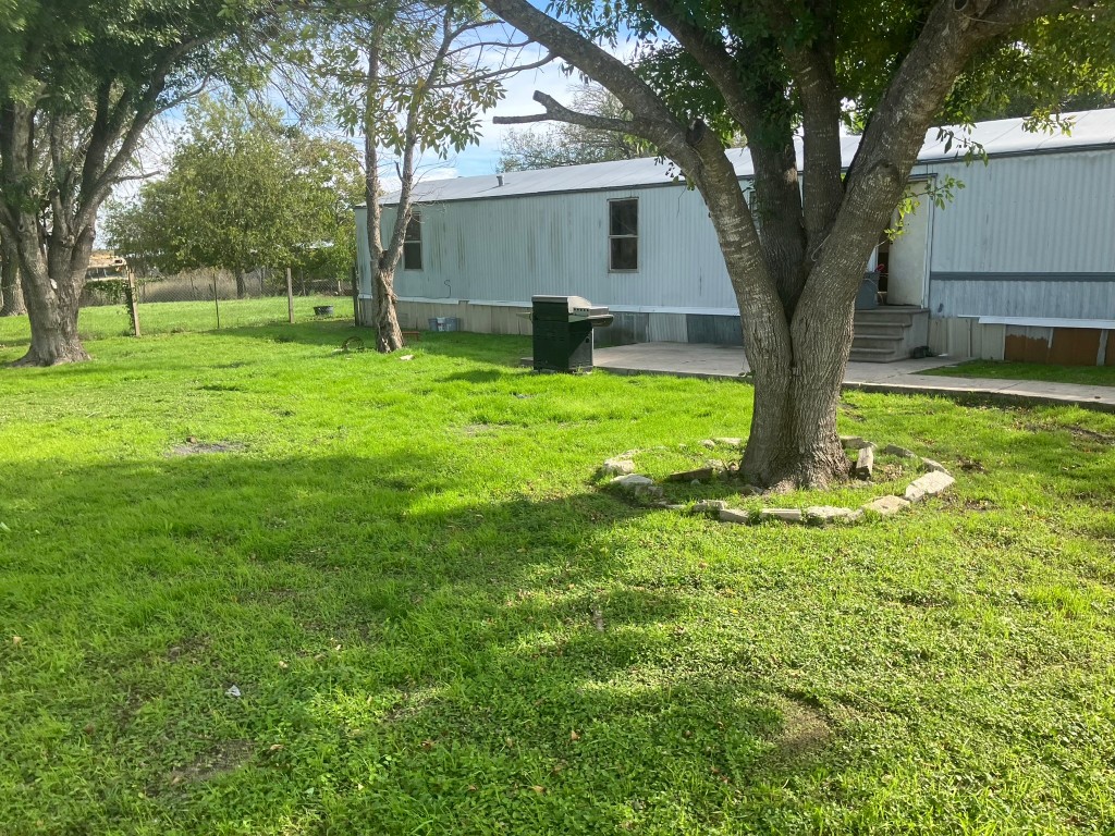 a view of a house with a backyard