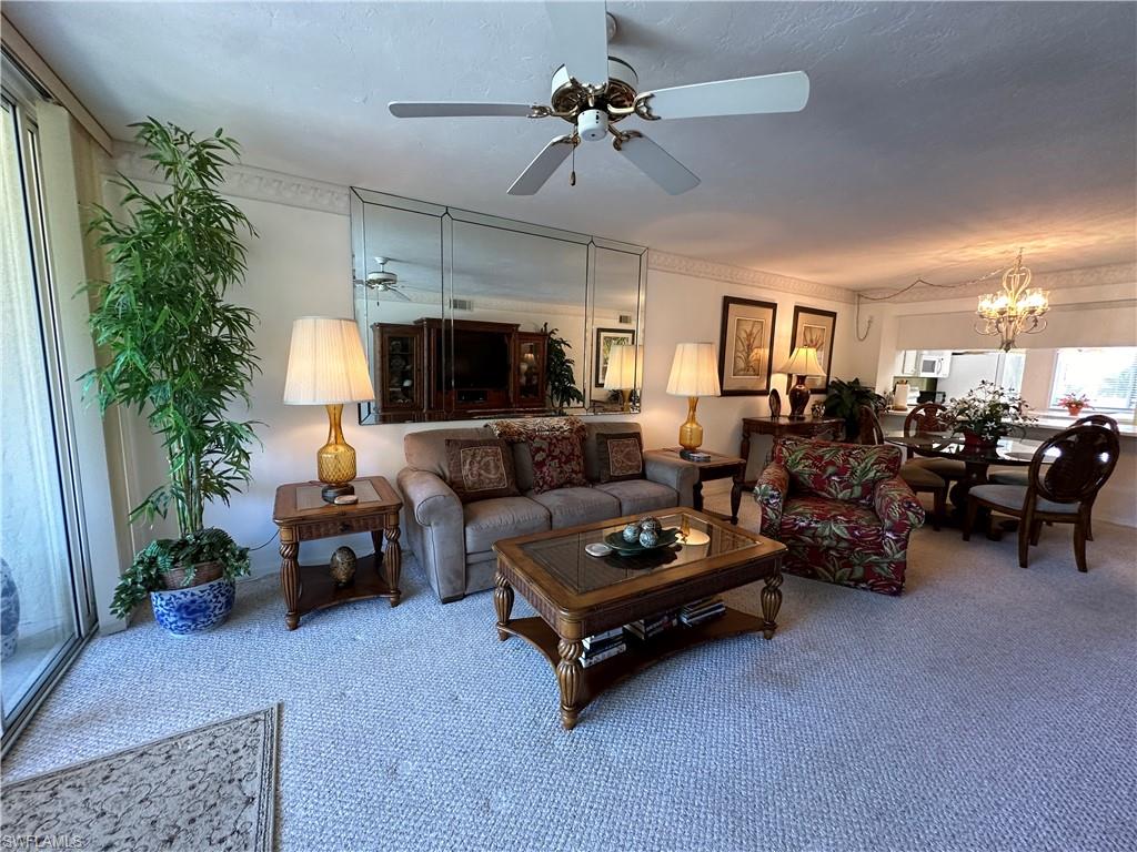 a living room with furniture a fireplace and a potted plant