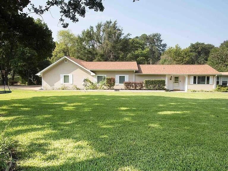 a view of house that has a yard