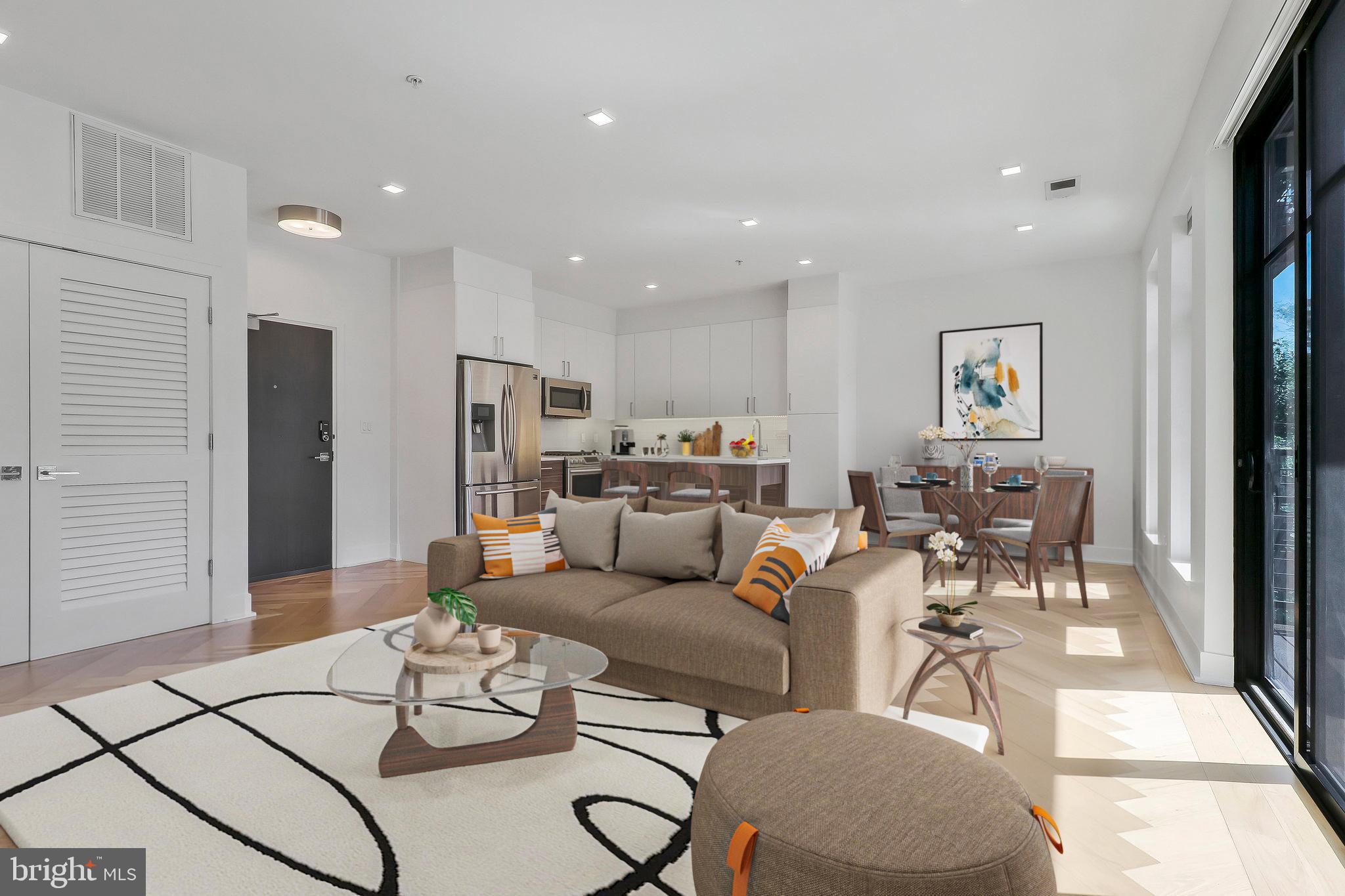 a living room with furniture and kitchen view