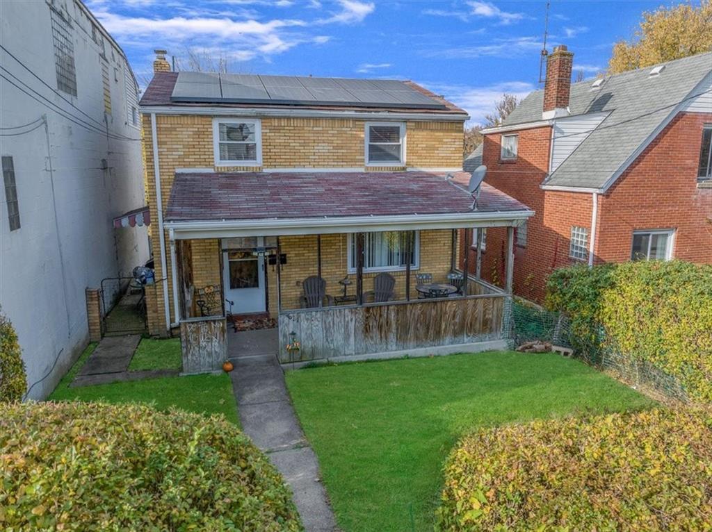 a front view of a house with a yard and porch