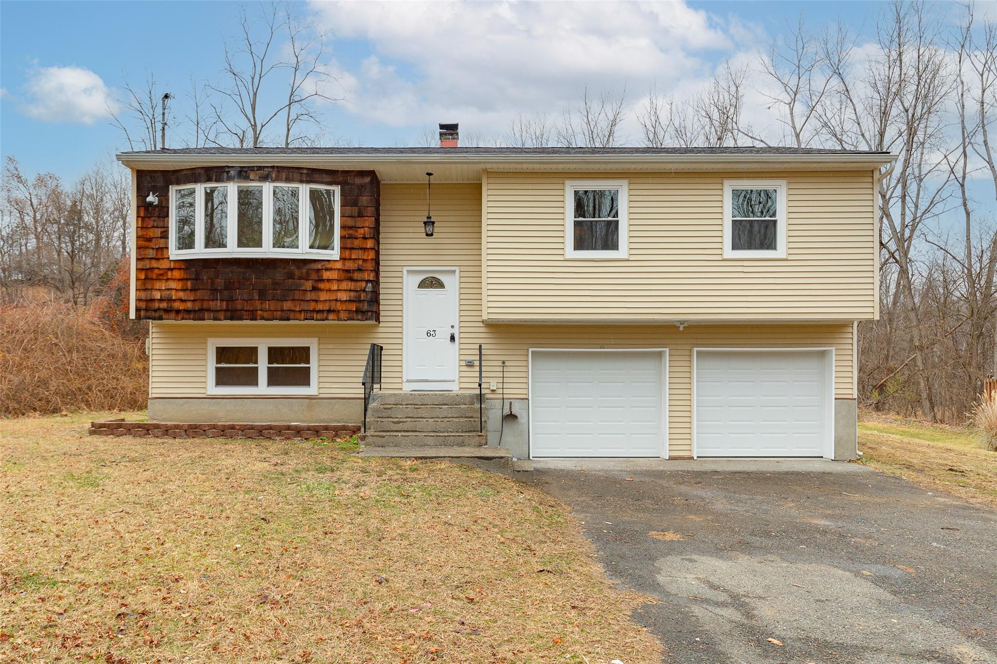 a front view of a house with a yard and garage