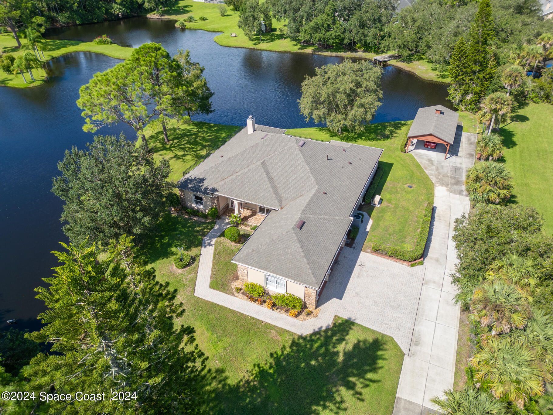 an aerial view of a house with a lake view