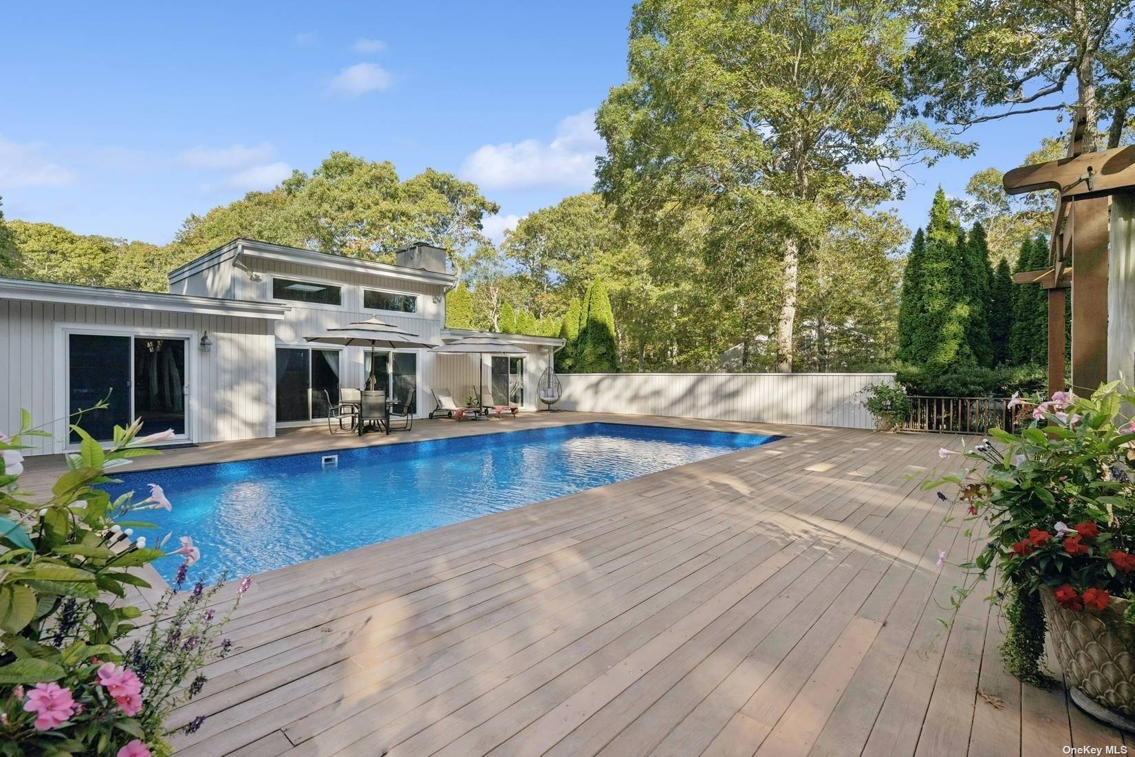 a view of a house with swimming pool and sitting area