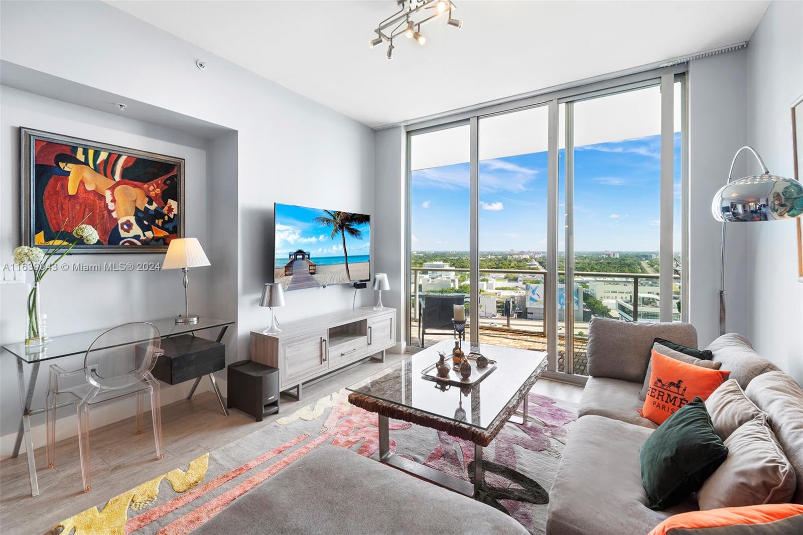 a living room with furniture a rug and a large window