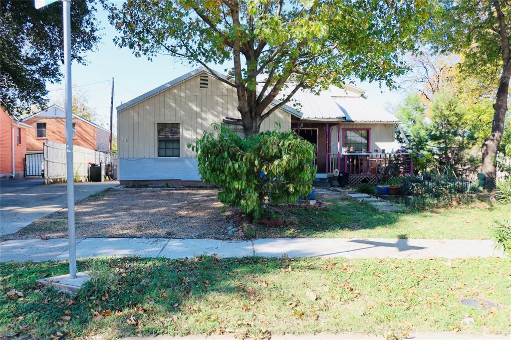 a front view of a house with a yard and a porch