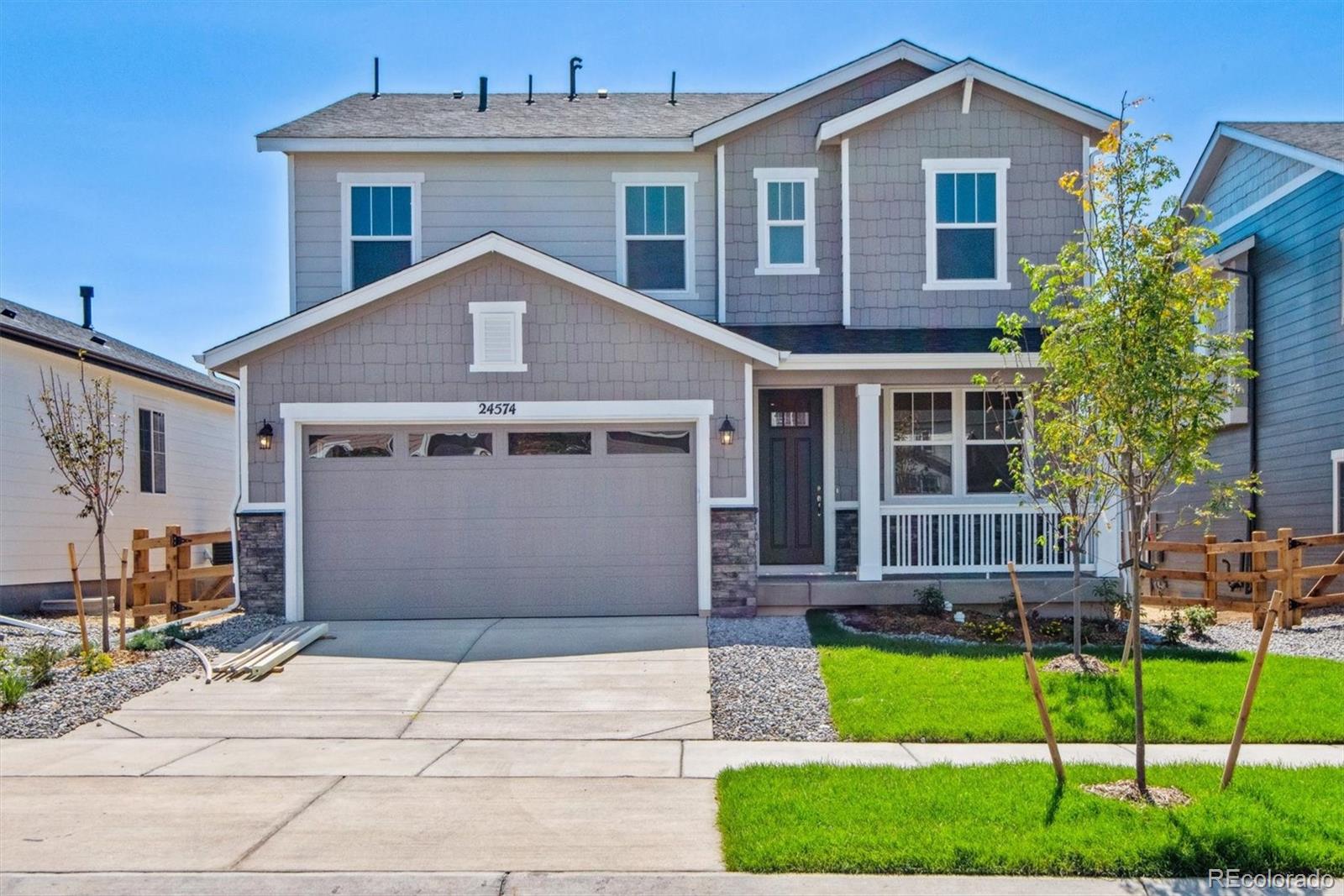 a front view of a house with a garden and plants