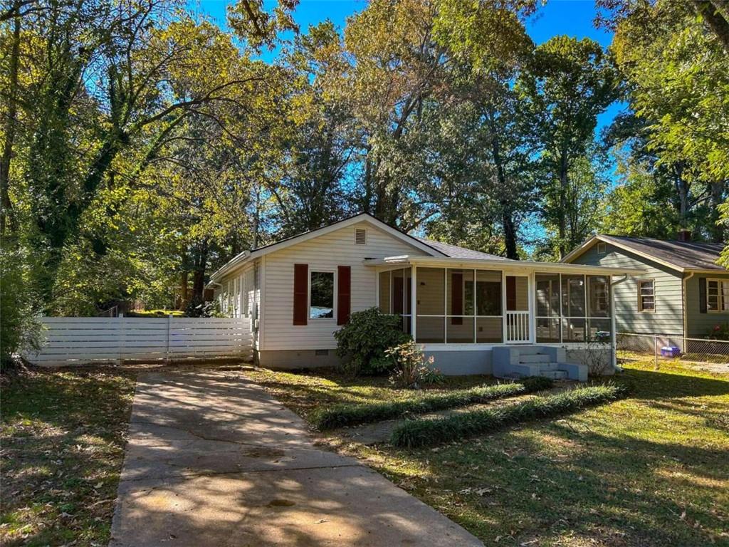 a front view of a house with a yard and trees