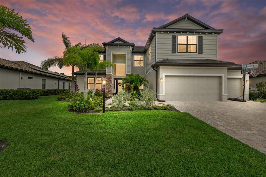 a front view of a house with a garden and plants