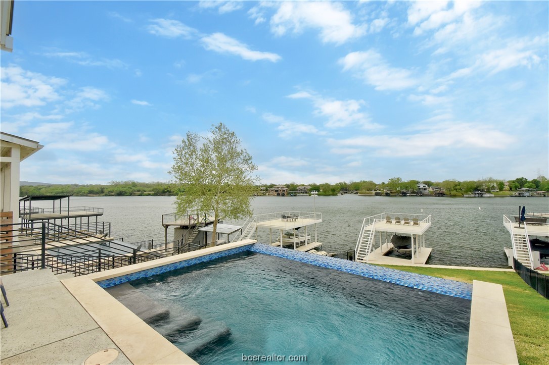 a view of a lake with couches chairs