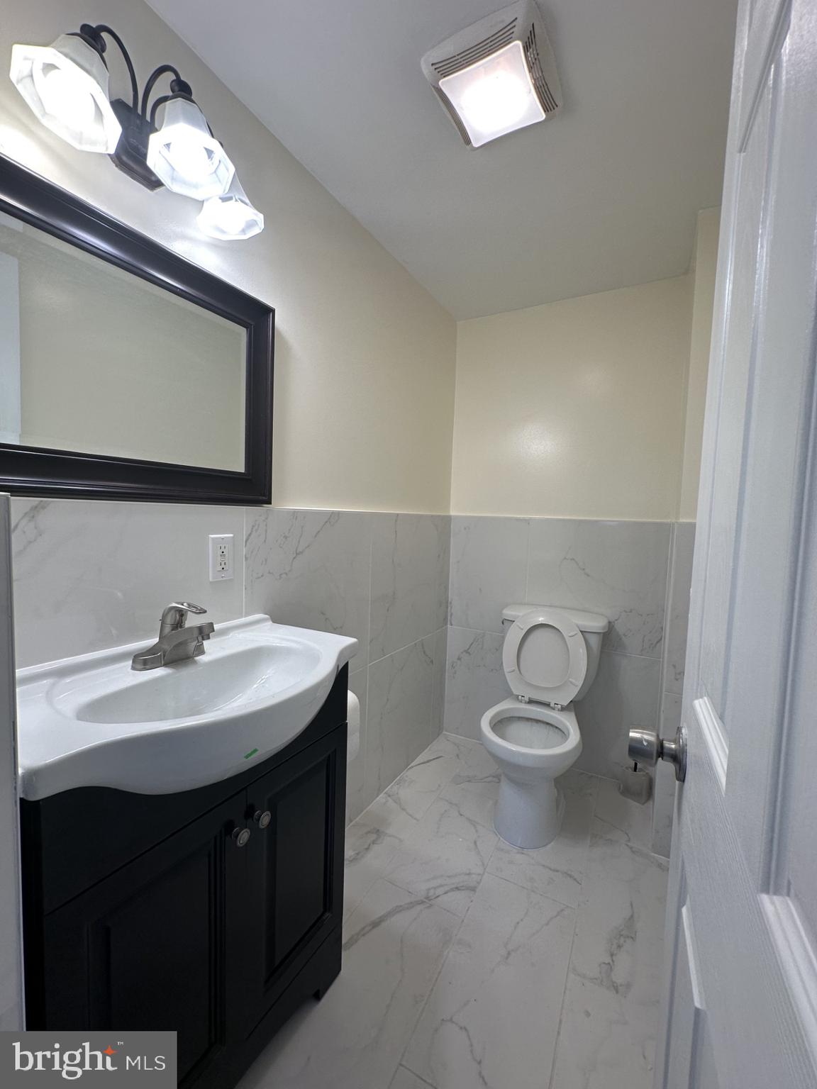 a bathroom with a sink toilet and mirror