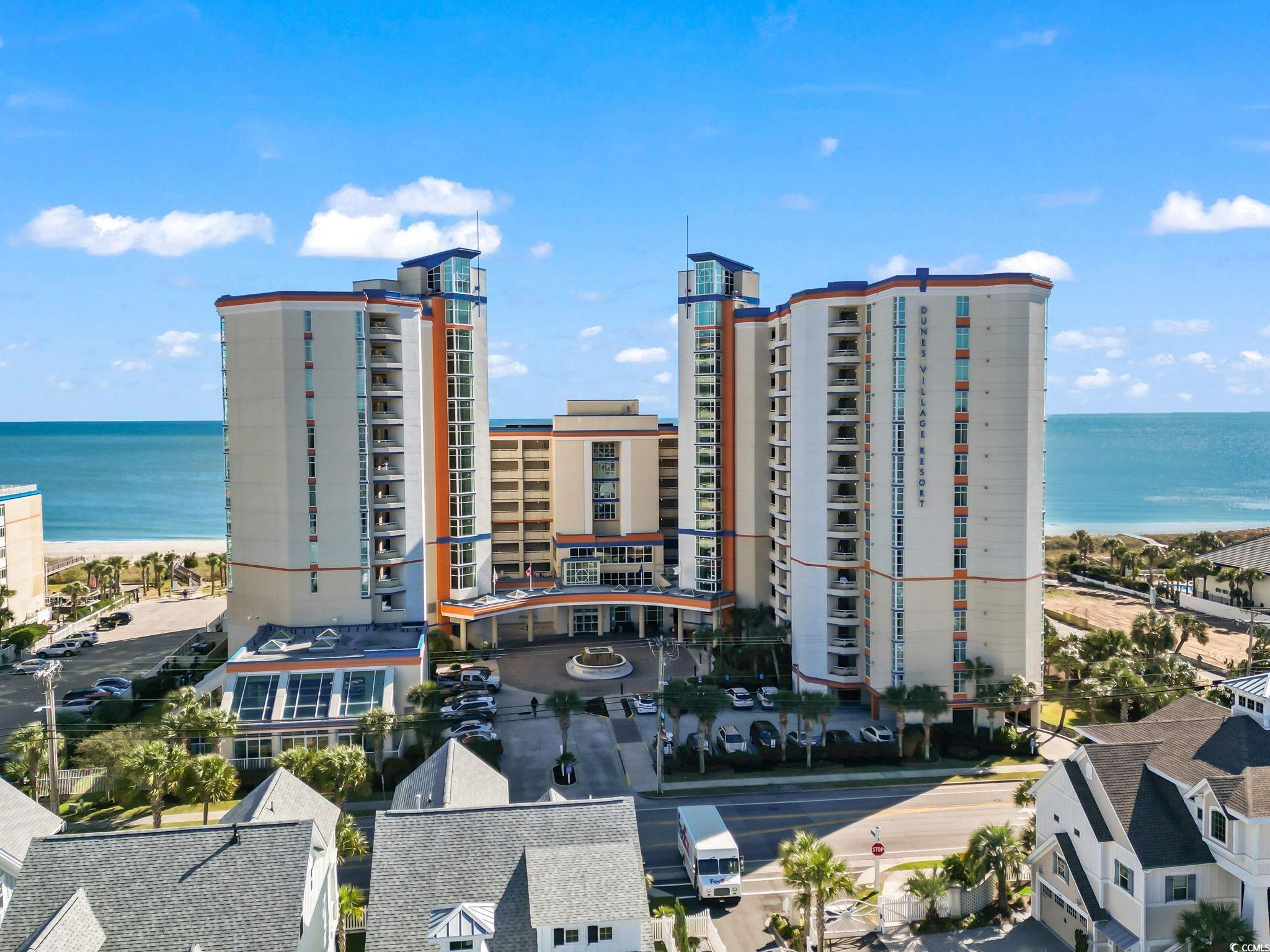 Birds eye view of property with a water view